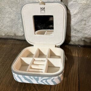 Milly traveling jewelry case in a white and gray zebra print.